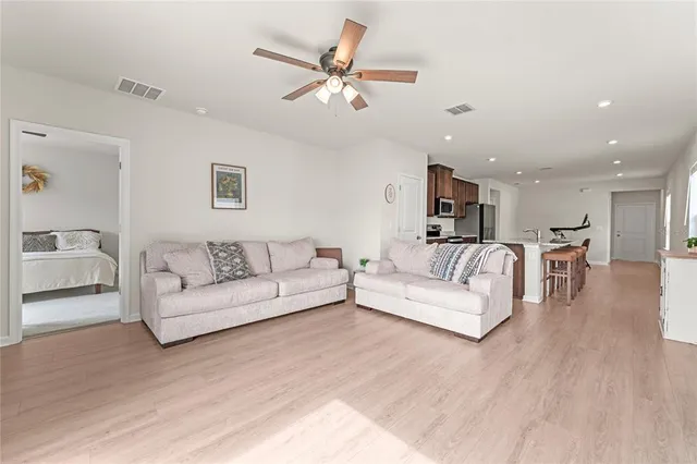 a living room with furniture and a wooden floor