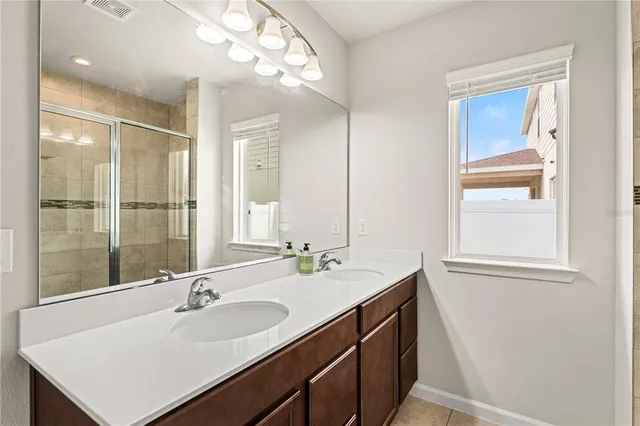 a bathroom with a sink double vanity and a mirror