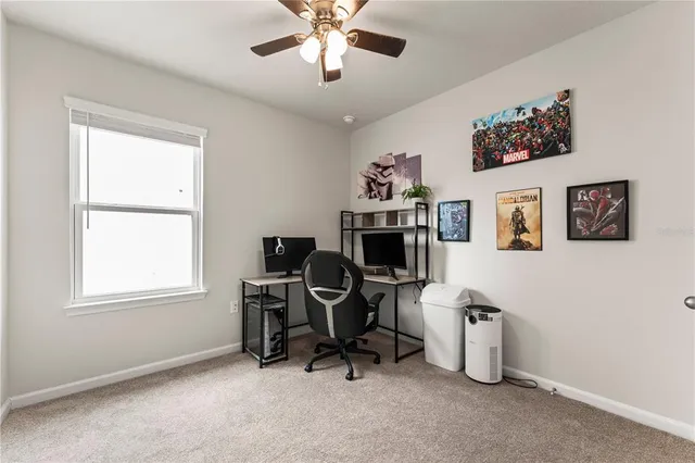 a view of a workspace with furniture and a window