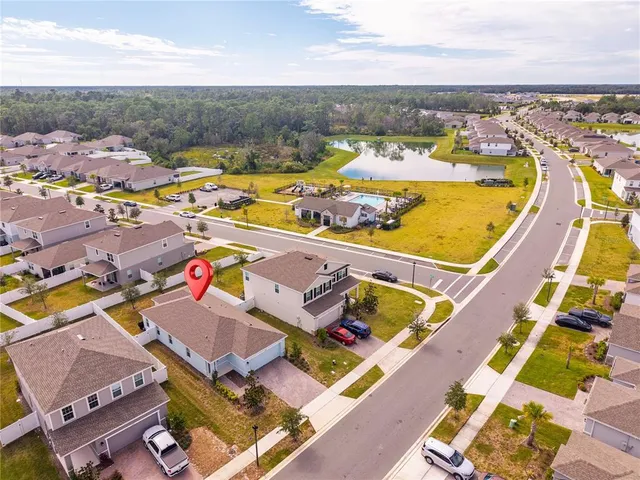 an aerial view of residential houses with outdoor space