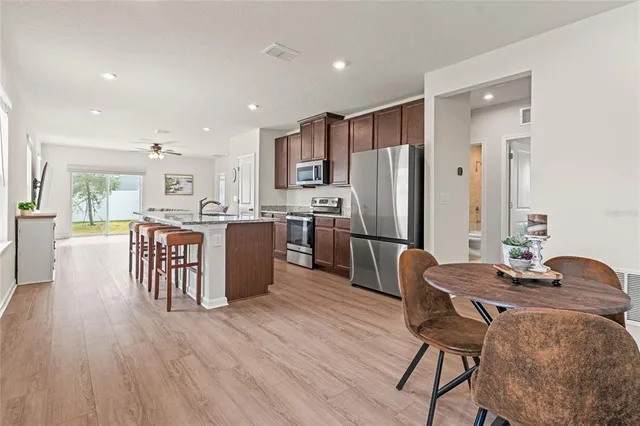 a large kitchen with a table and chairs