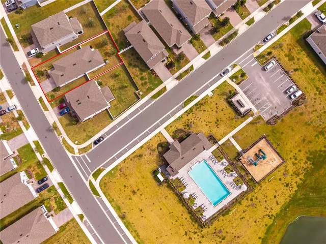 an aerial view of residential houses with outdoor space