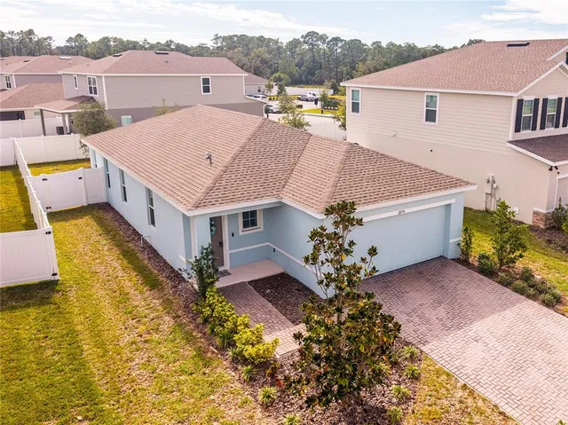 an aerial view of a house with a swimming pool yard and outdoor seating