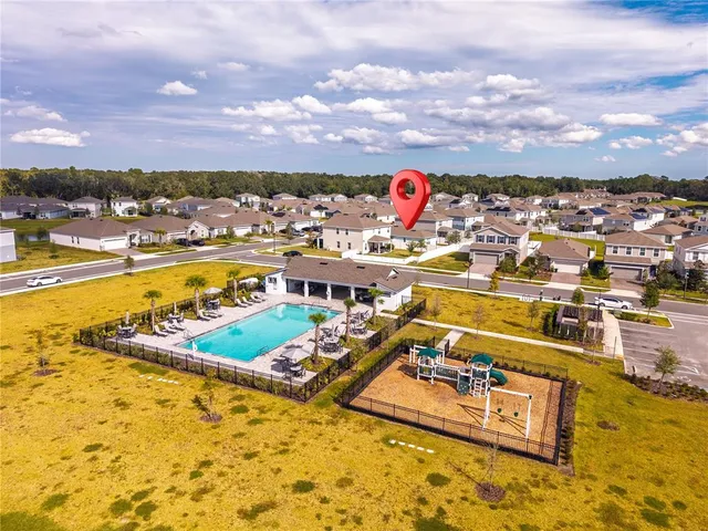 an aerial view of a swimming pool and lake view