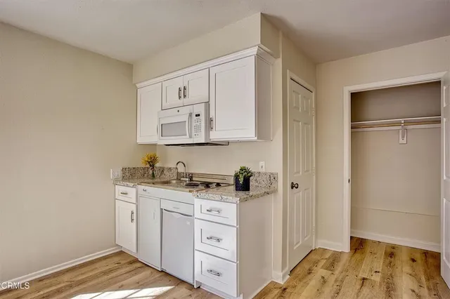 a kitchen with stainless steel appliances a stove and cabinets