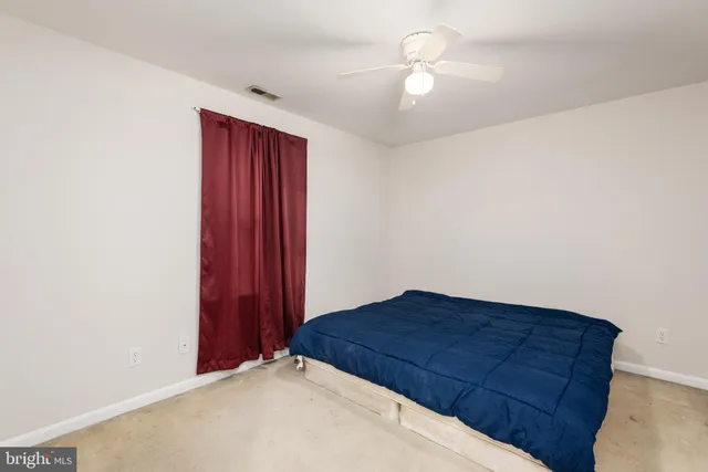 a view of workspace with furniture and a fan
