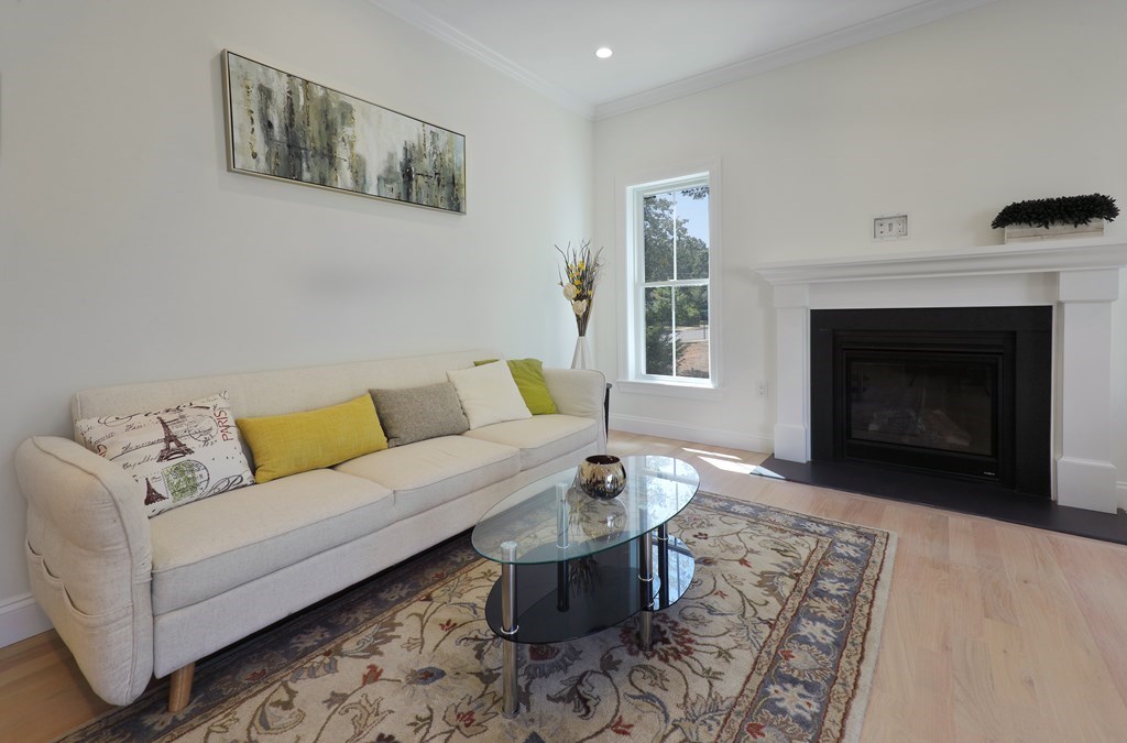 134 Spiers Road Newton, MA 02459 - Photo 12 of 38 a living room with furniture a window and a fireplace