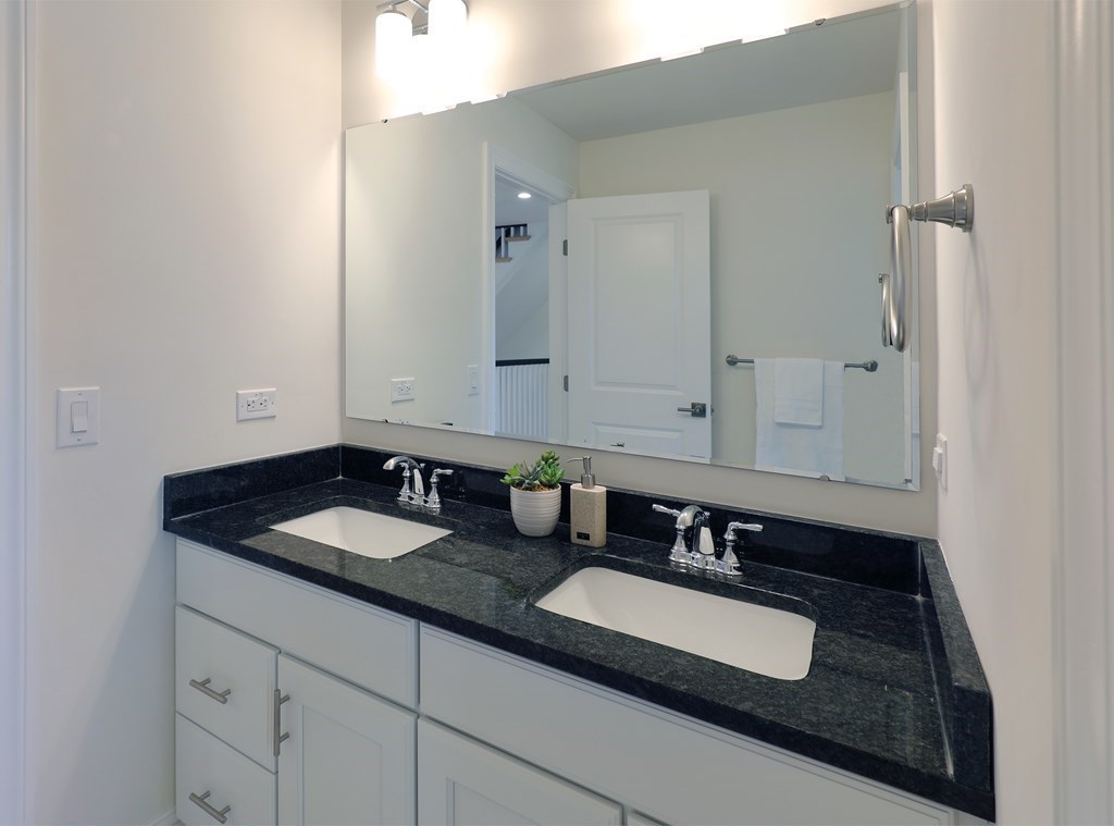 134 Spiers Road Newton, MA 02459 - Photo 17 of 38 a bathroom with double sink and a mirror