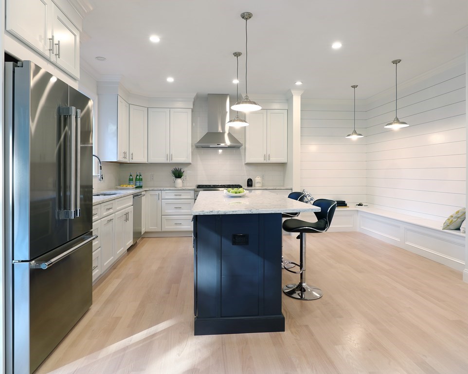134 Spiers Road Newton, MA 02459 - Photo 2 of 38 a kitchen with kitchen island stainless steel appliances a sink cabinets and wooden floor