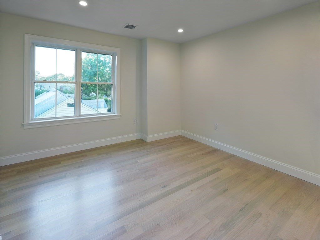 134 Spiers Road Newton, MA 02459 - Photo 22 of 38 an empty room with wooden floor and windows