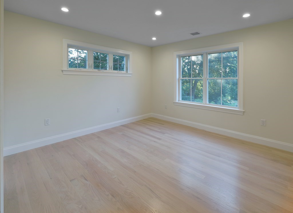 134 Spiers Road Newton, MA 02459 - Photo 25 of 38 an empty room with wooden floor and windows