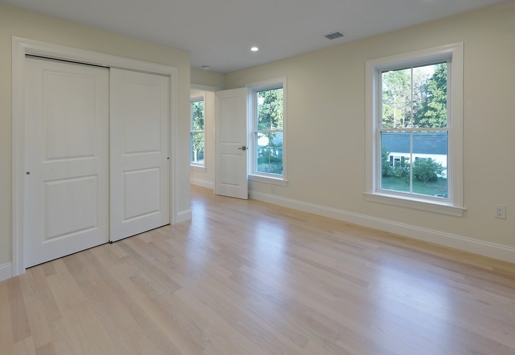 134 Spiers Road Newton, MA 02459 - Photo 32 of 38 an empty room with wooden floor and windows