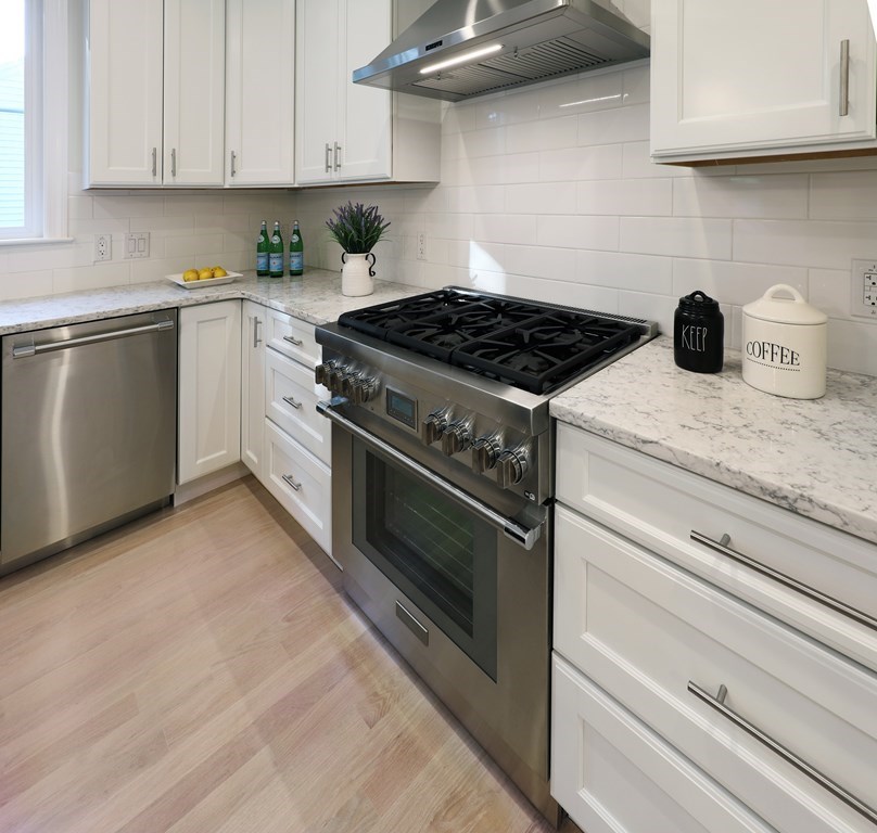 134 Spiers Road Newton, MA 02459 - Photo 10 of 38 a kitchen with granite countertop cabinets stainless steel appliances and a wooden floor