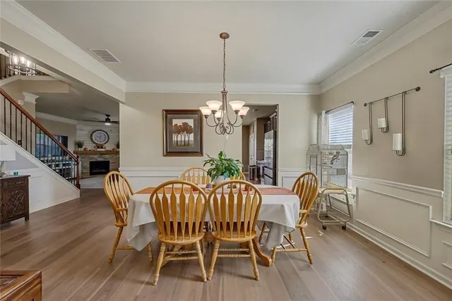a kitchen with a table chairs refrigerator and cabinets