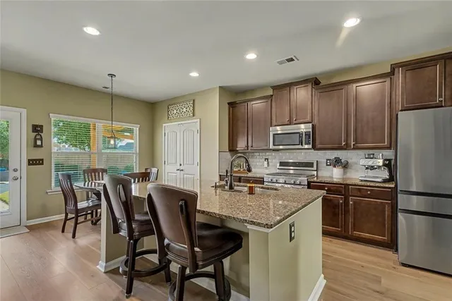 a bedroom with a bed and a flat tv screen on dresser