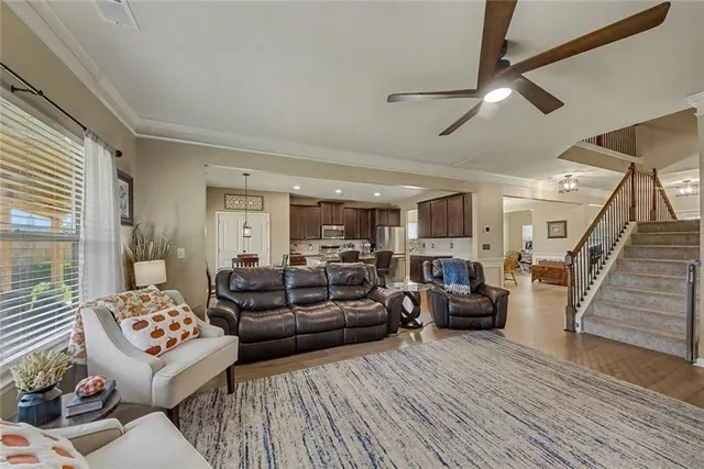 a living room with furniture kitchen view and a fireplace