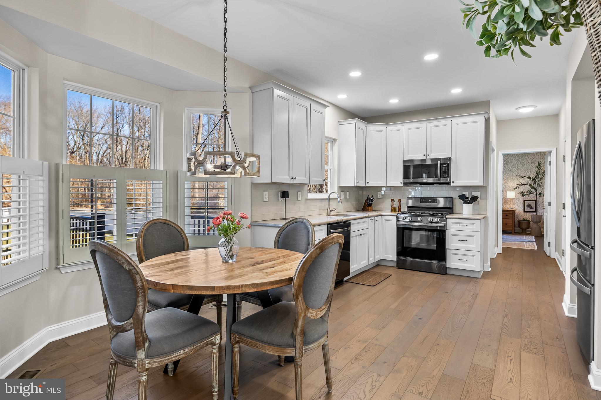 4907 Church Road Mount Laurel, NJ 08054 - Photo 13 of 49 a kitchen with a dining table chairs stainless steel appliances and windows