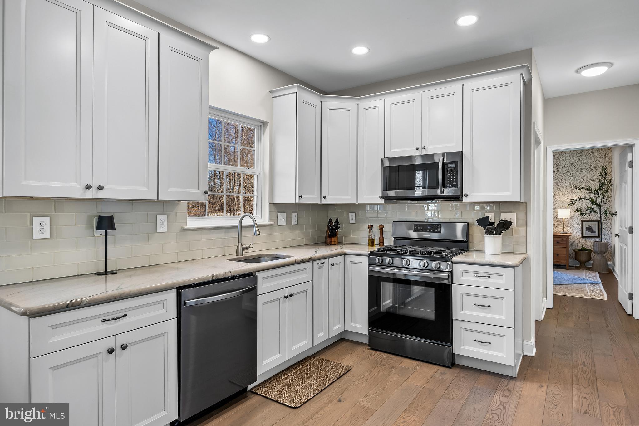 4907 Church Road Mount Laurel, NJ 08054 - Photo 14 of 49 a kitchen with stainless steel appliances granite countertop a stove sink and cabinets