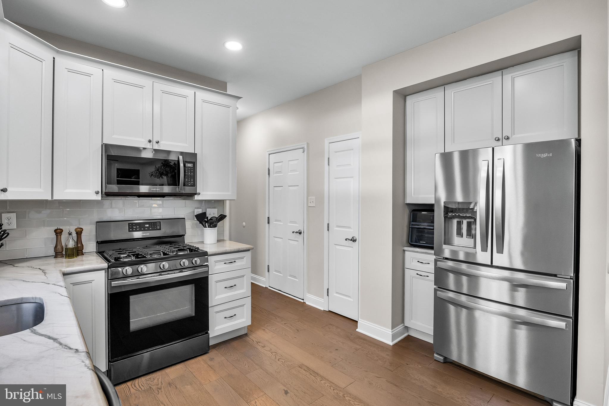 4907 Church Road Mount Laurel, NJ 08054 - Photo 16 of 49 a kitchen with cabinets stainless steel appliances and wooden floor