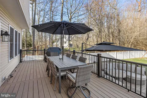 a view of a roof deck with furniture