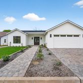 a view of a house with a yard and garage
