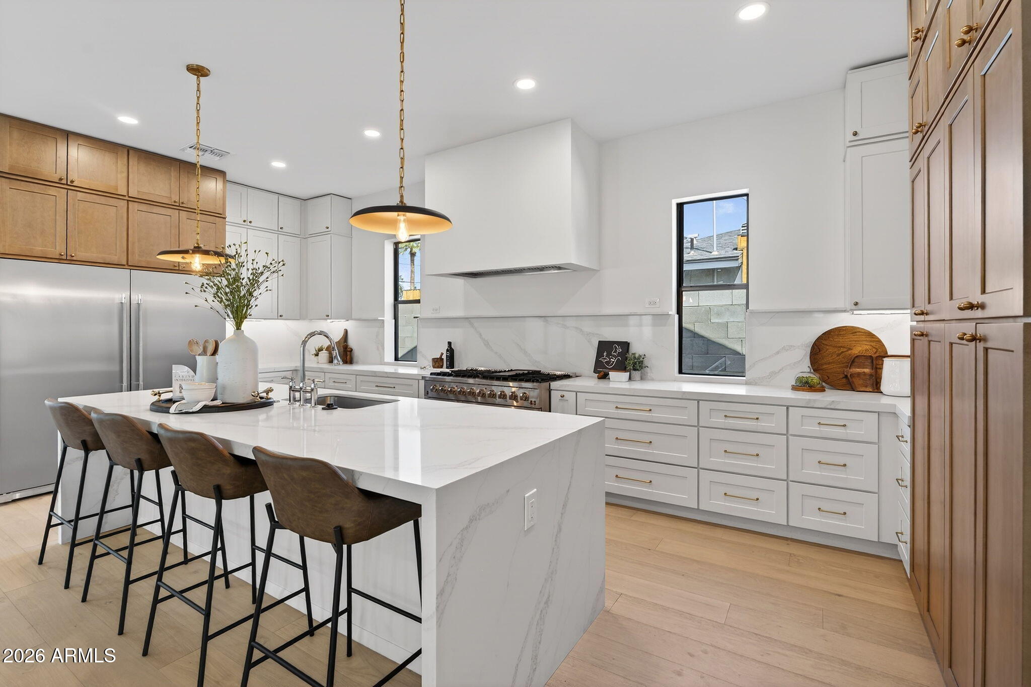 6818 North 13th Street Phoenix, AZ 85014 - Photo 13 of 65 a kitchen with stainless steel appliances kitchen island granite countertop a table chairs sink and cabinets