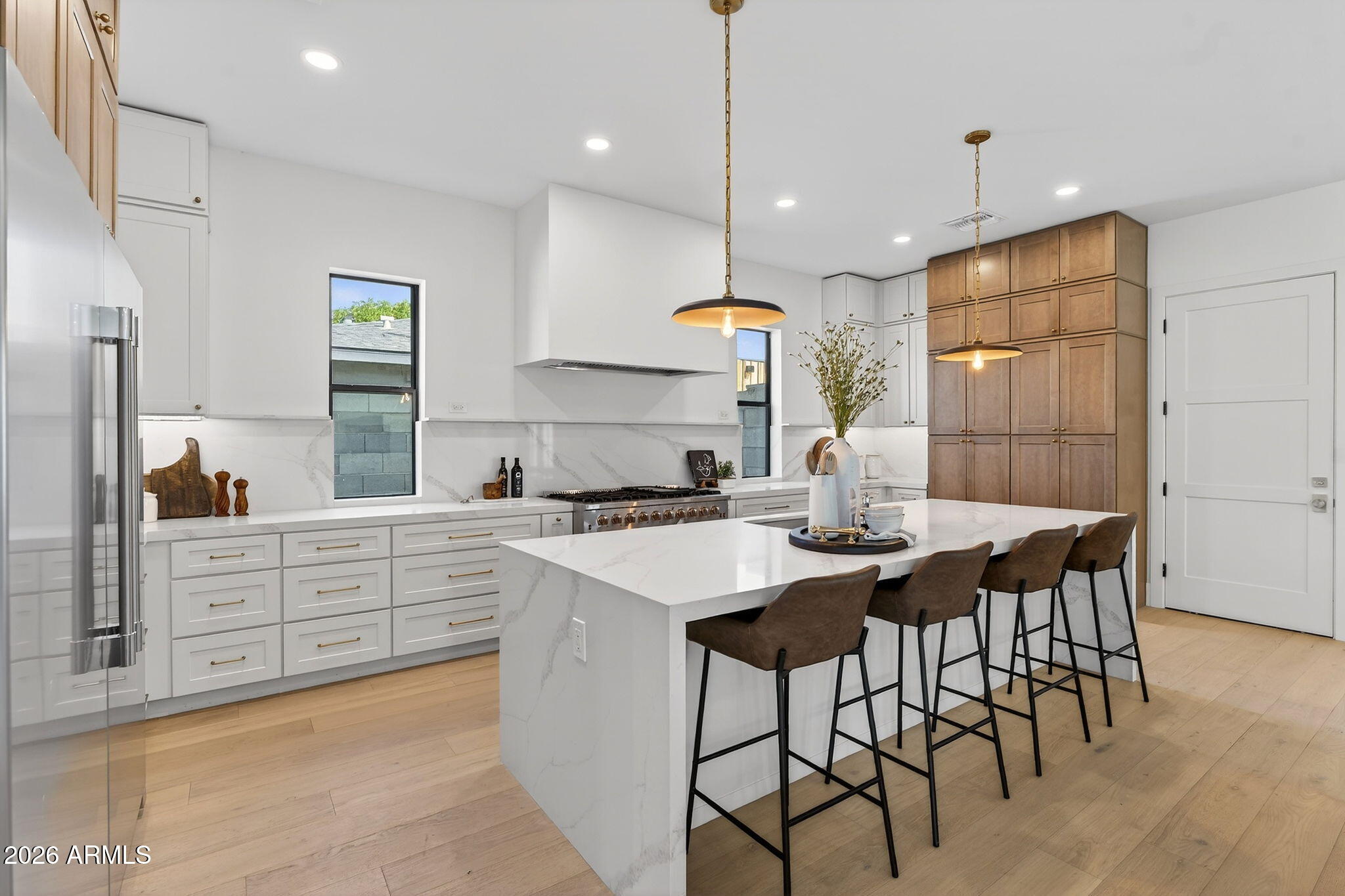 6818 North 13th Street Phoenix, AZ 85014 - Photo 14 of 65 a kitchen with stainless steel appliances kitchen island granite countertop a table chairs sink and cabinets