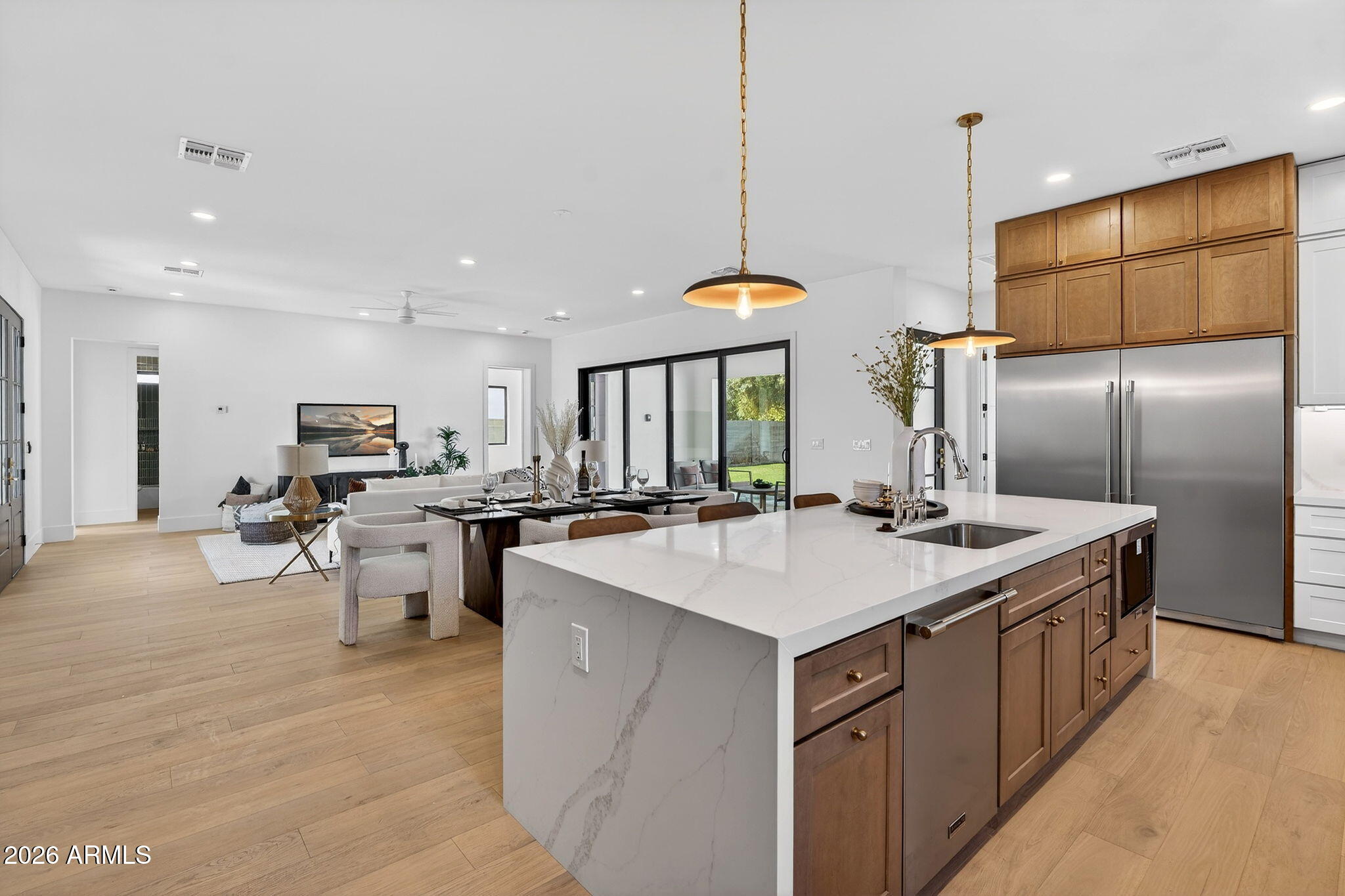 6818 North 13th Street Phoenix, AZ 85014 - Photo 16 of 65 a kitchen with stainless steel appliances kitchen island a sink a refrigerator and chairs