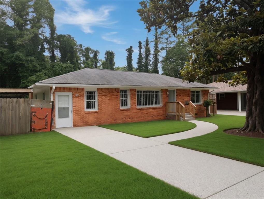 1189 Rock Cut Road Forest Park, GA 30297 - Photo 2 of 23 a front view of a house with a garden and yard