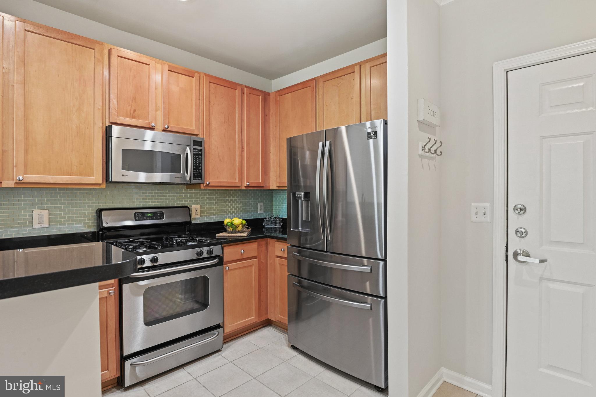 12000 Market Street, Unit 343 Reston, VA 20190 - Photo 4 of 46 Pretty tile backsplash adds a hint of color
