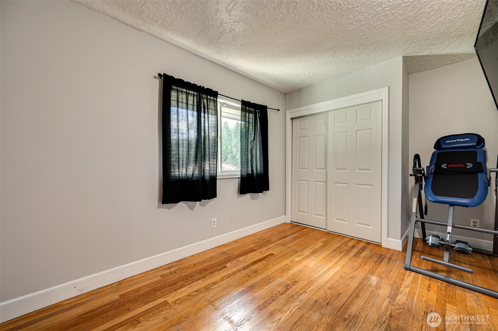 2126 Lewis River Road Woodland, WA 98674 - Photo 9 of 23 a view of an empty room with wooden floor and a window