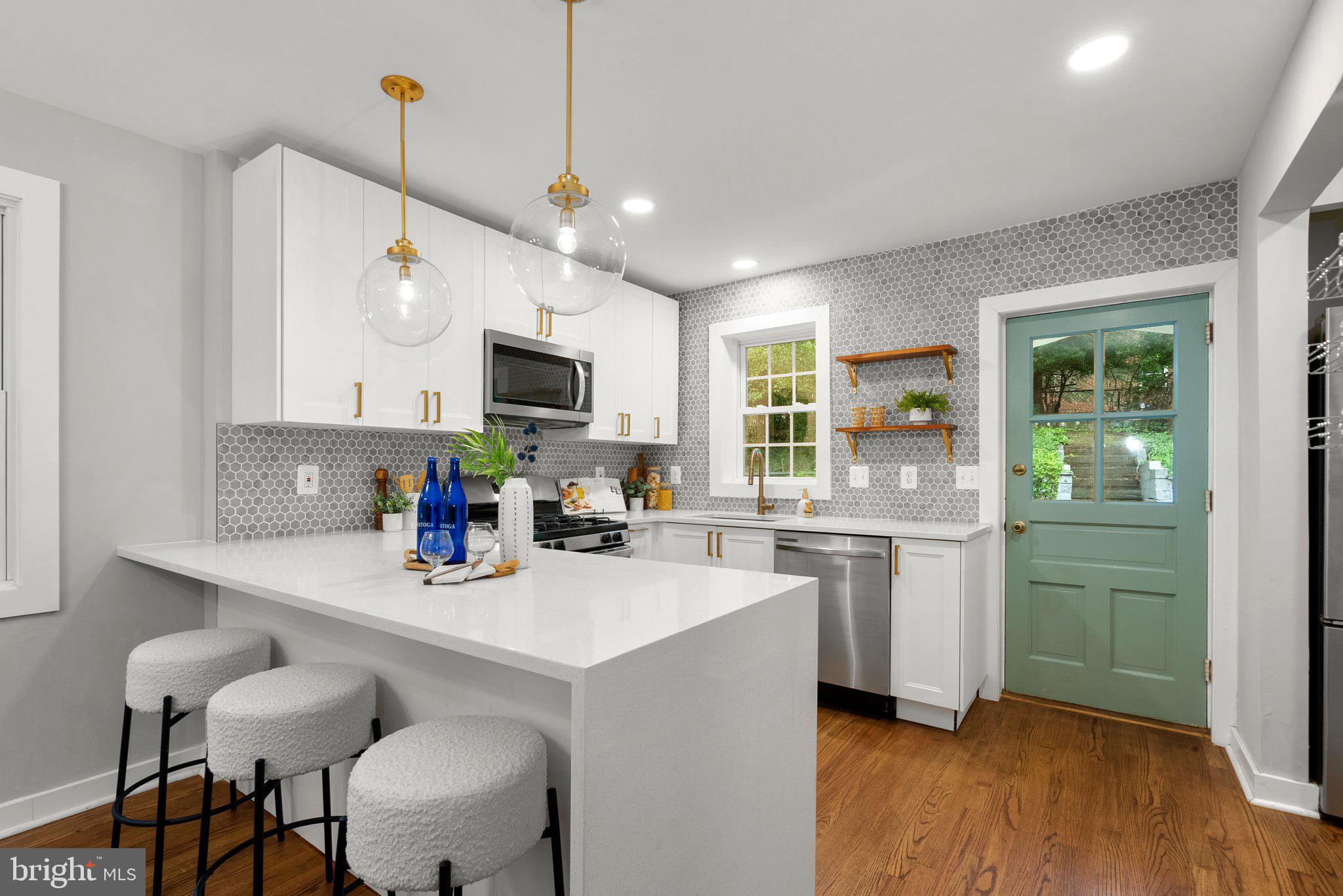 8713 Reading Road Silver Spring, MD 20901 - Photo 14 of 49 a kitchen with a sink cabinets and wooden floor
