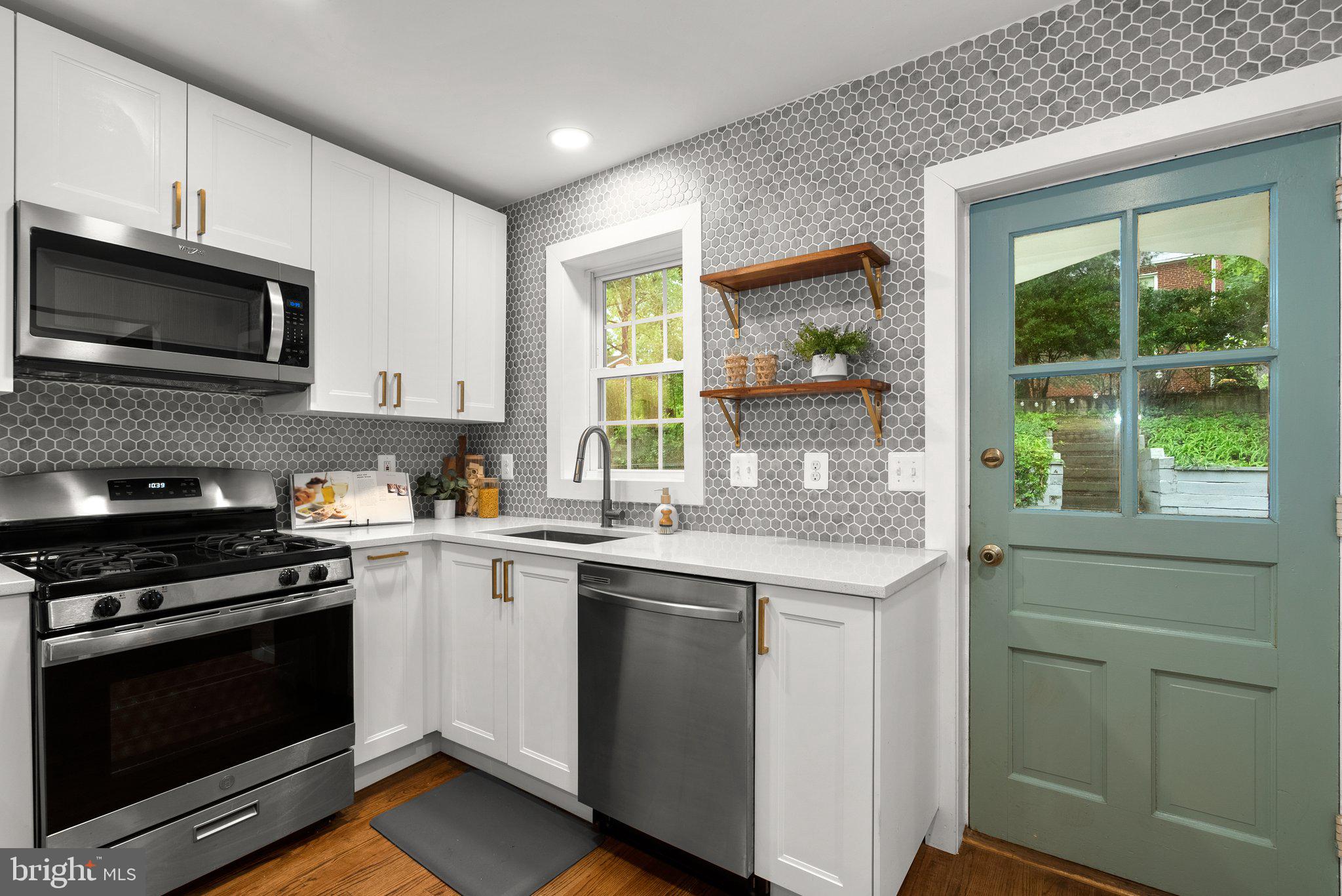 8713 Reading Road Silver Spring, MD 20901 - Photo 15 of 49 a kitchen with a sink stove and microwave