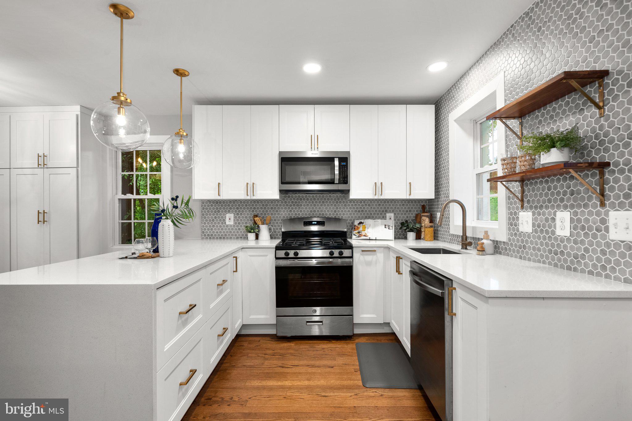 8713 Reading Road Silver Spring, MD 20901 - Photo 16 of 49 a kitchen with stainless steel appliances granite countertop a sink and a stove