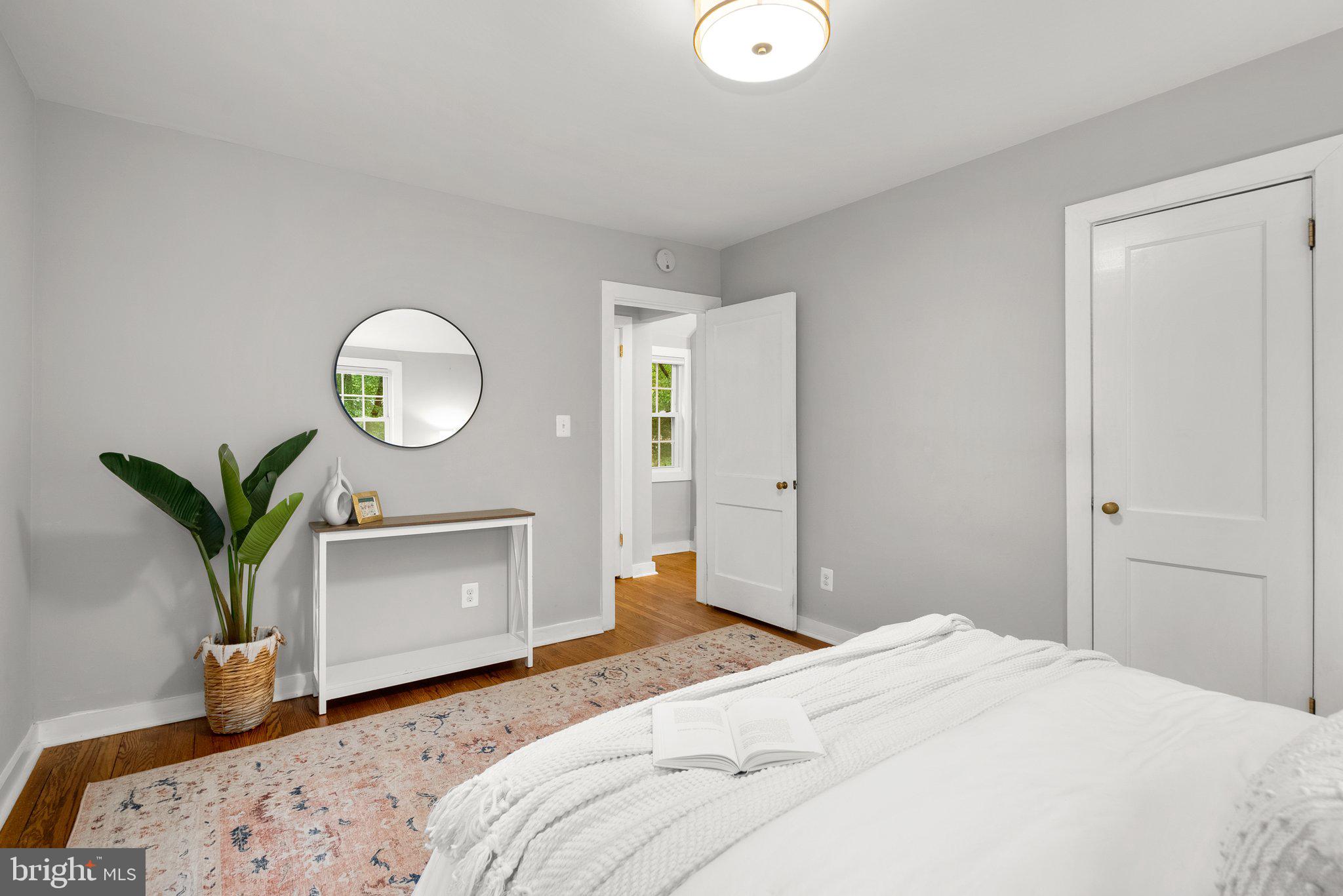 8713 Reading Road Silver Spring, MD 20901 - Photo 21 of 49 a bedroom with a bed and a potted plant