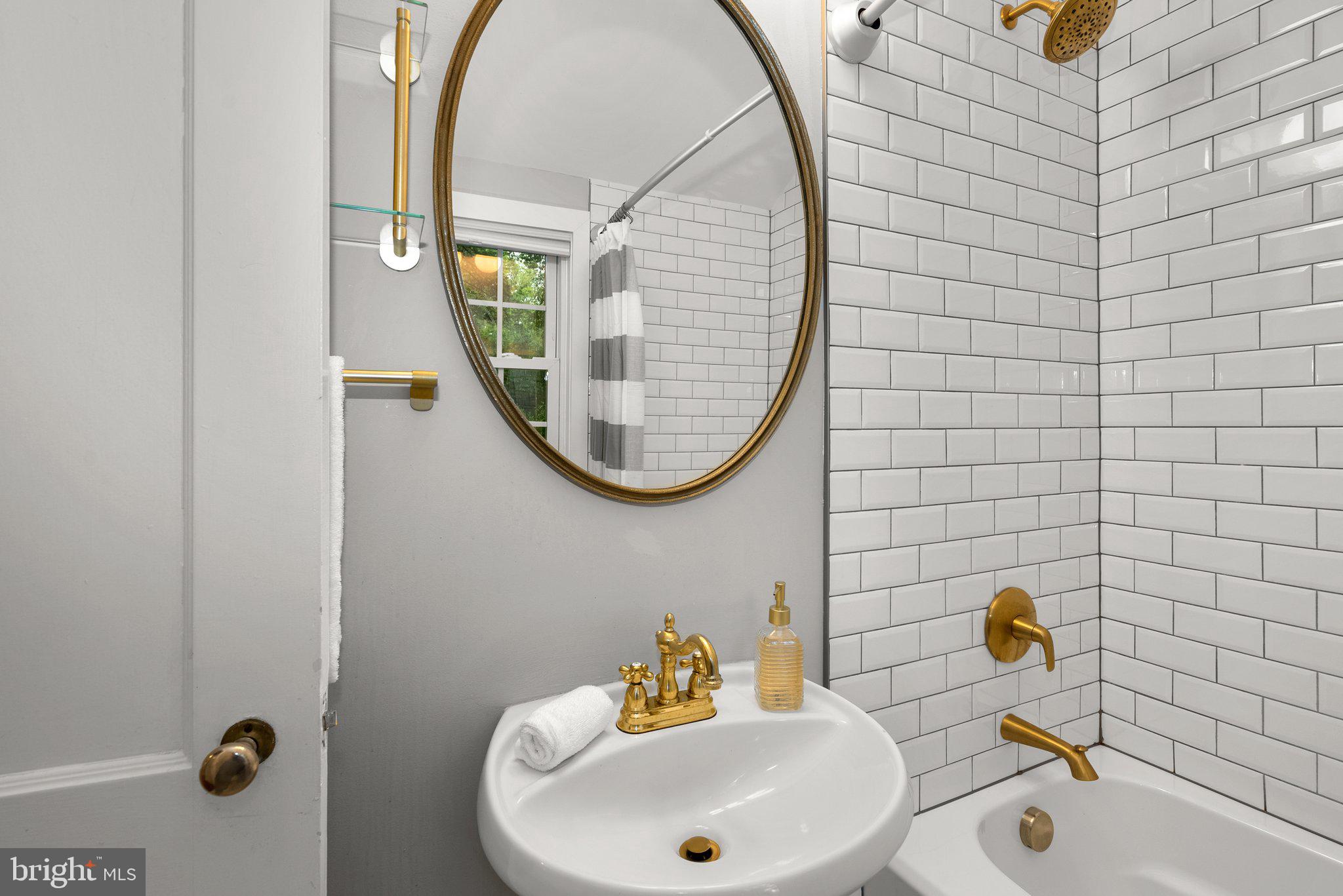 8713 Reading Road Silver Spring, MD 20901 - Photo 27 of 49 a bathroom with a sink a mirror and a window