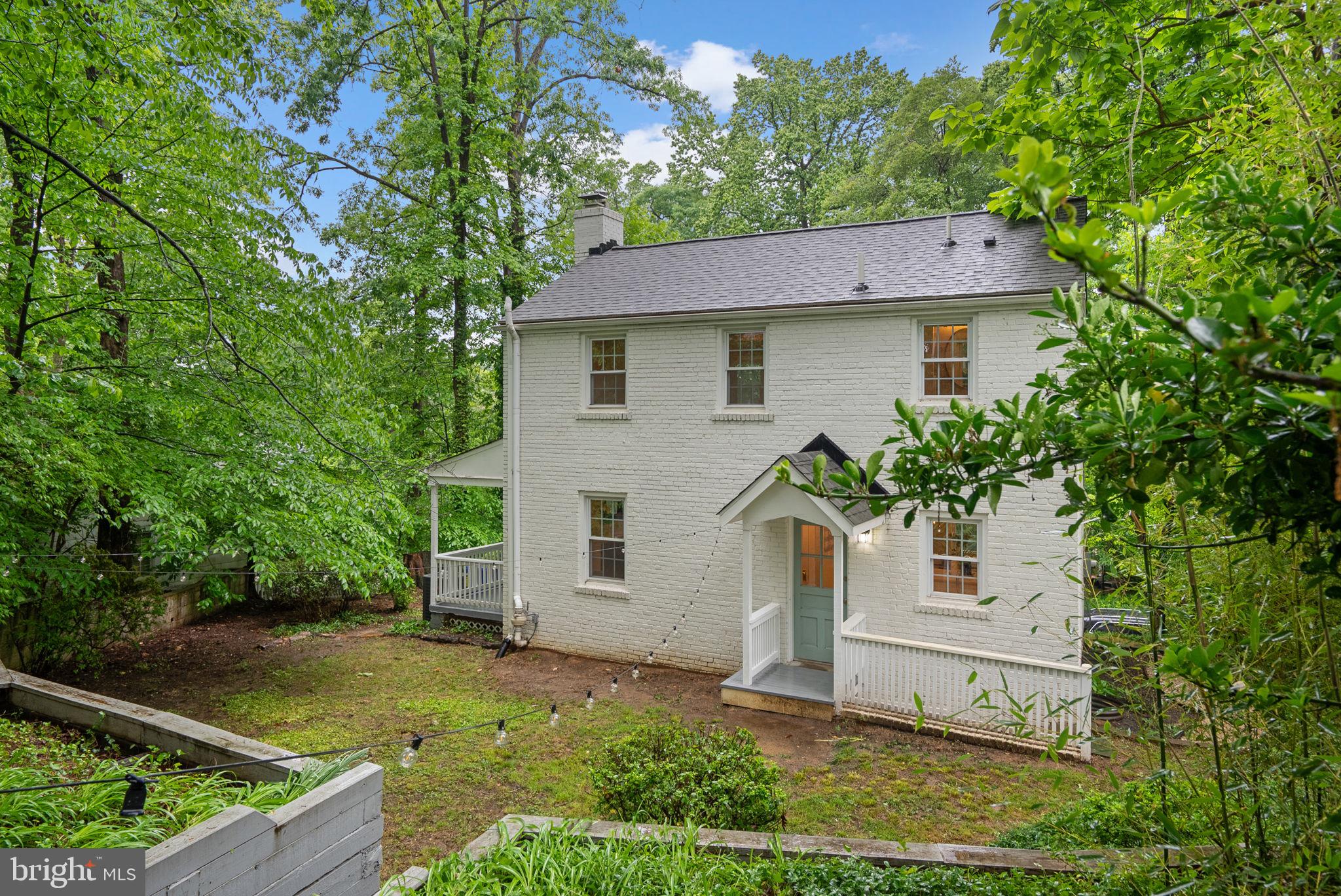 8713 Reading Road Silver Spring, MD 20901 - Photo 41 of 49 a view of a white house with a small yard plants and large tree