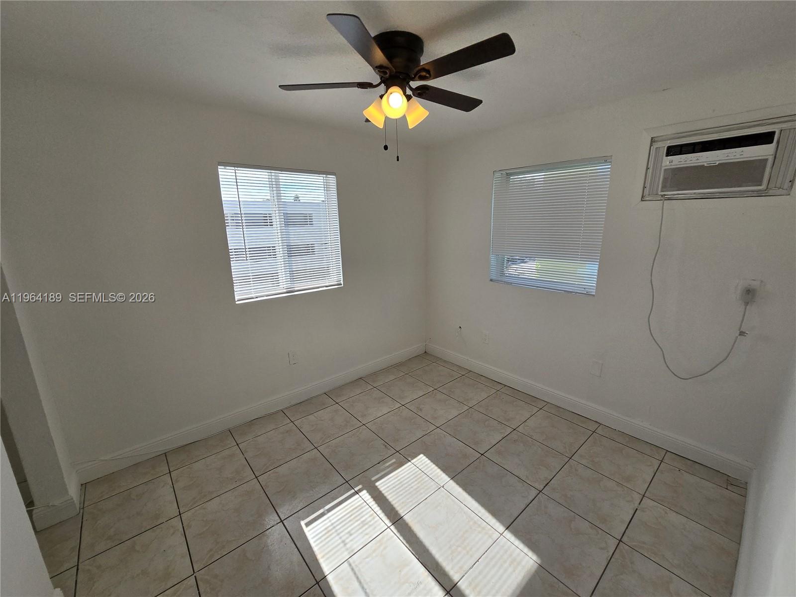 535 Northwest 7th Street, Unit 9 Miami, FL 33136 - Photo 12 of 22 a view of an empty room with a window