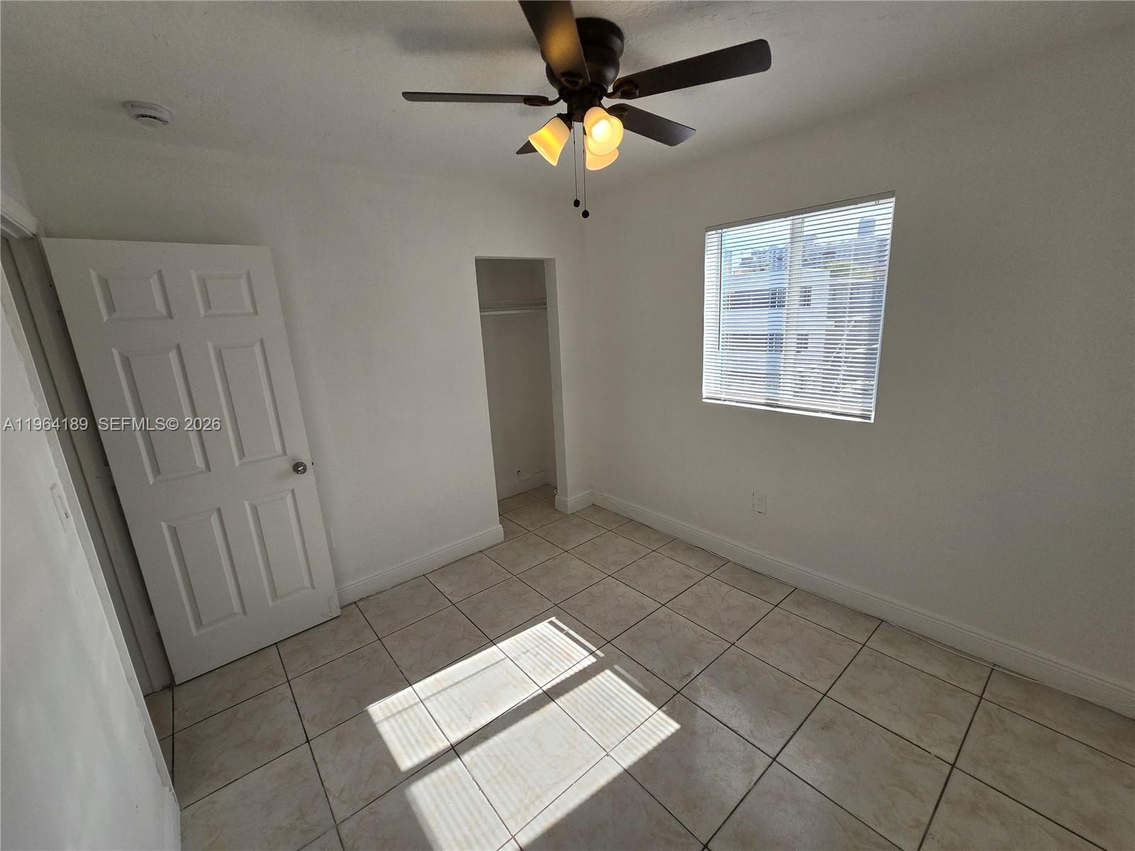 535 Northwest 7th Street, Unit 9 Miami, FL 33136 - Photo 13 of 22 a view of an empty room with a window