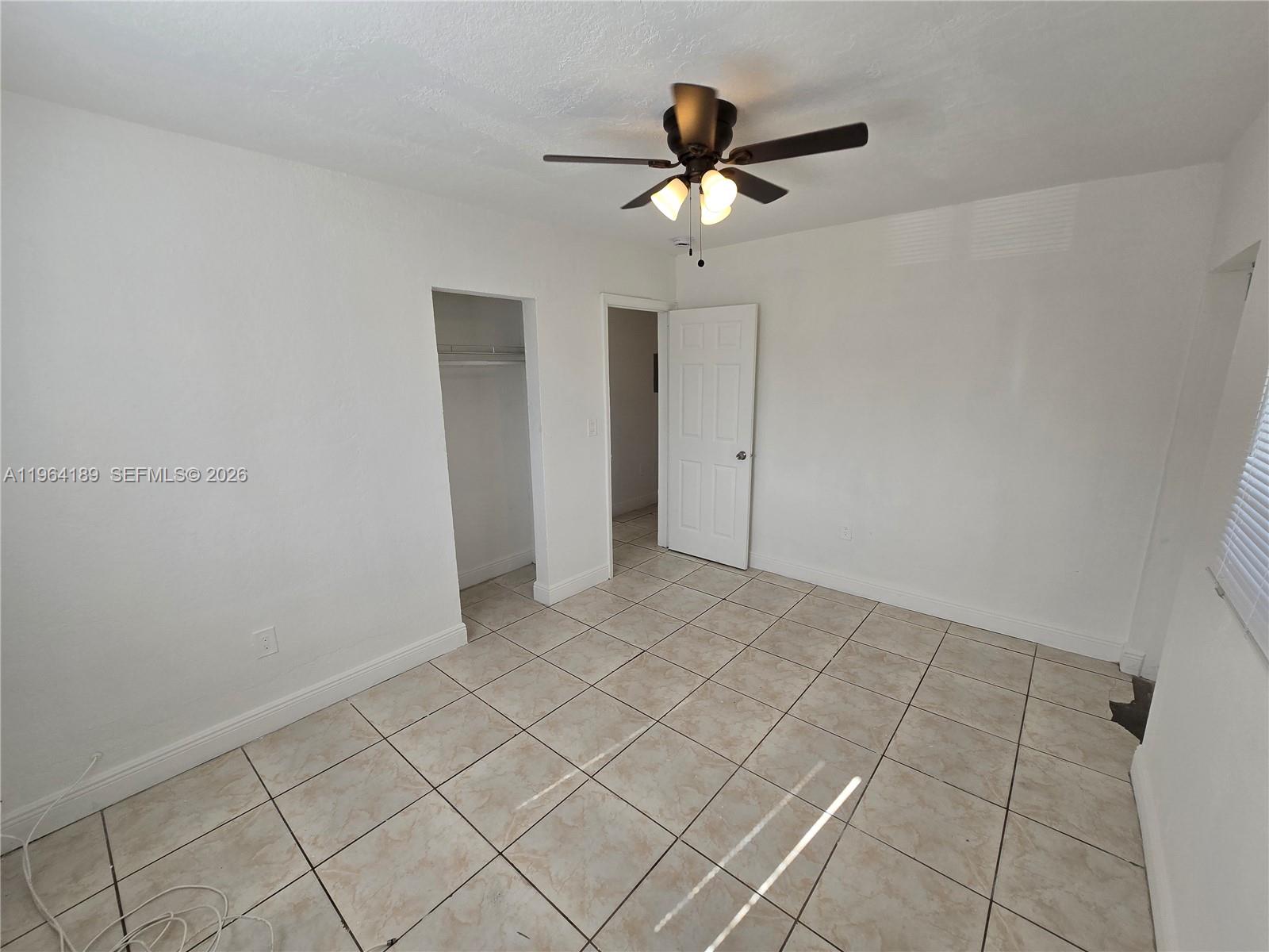 535 Northwest 7th Street, Unit 9 Miami, FL 33136 - Photo 17 of 22 a view of an empty room and chandelier fan