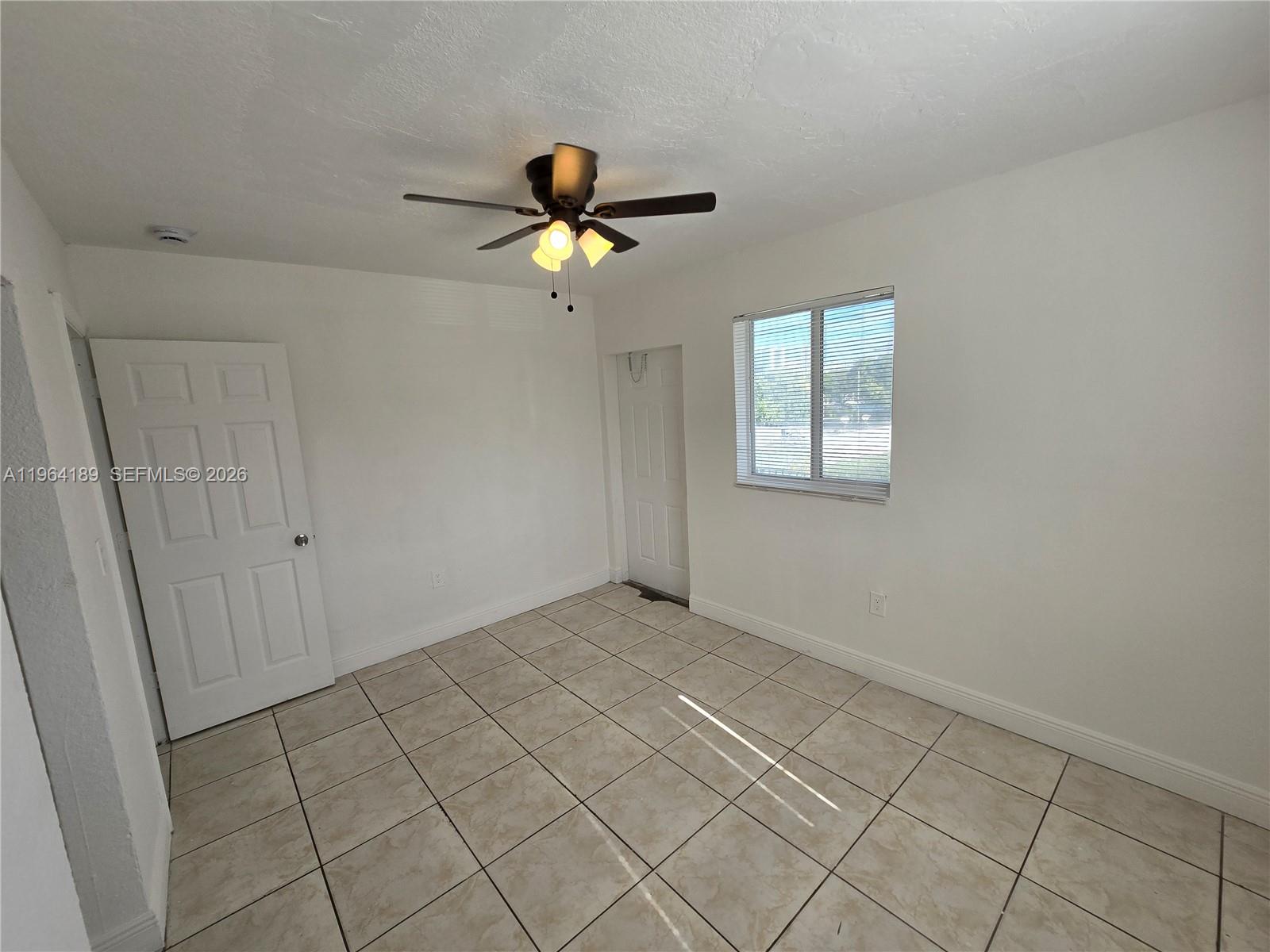 535 Northwest 7th Street, Unit 9 Miami, FL 33136 - Photo 18 of 22 wooden floor in an empty room with a window