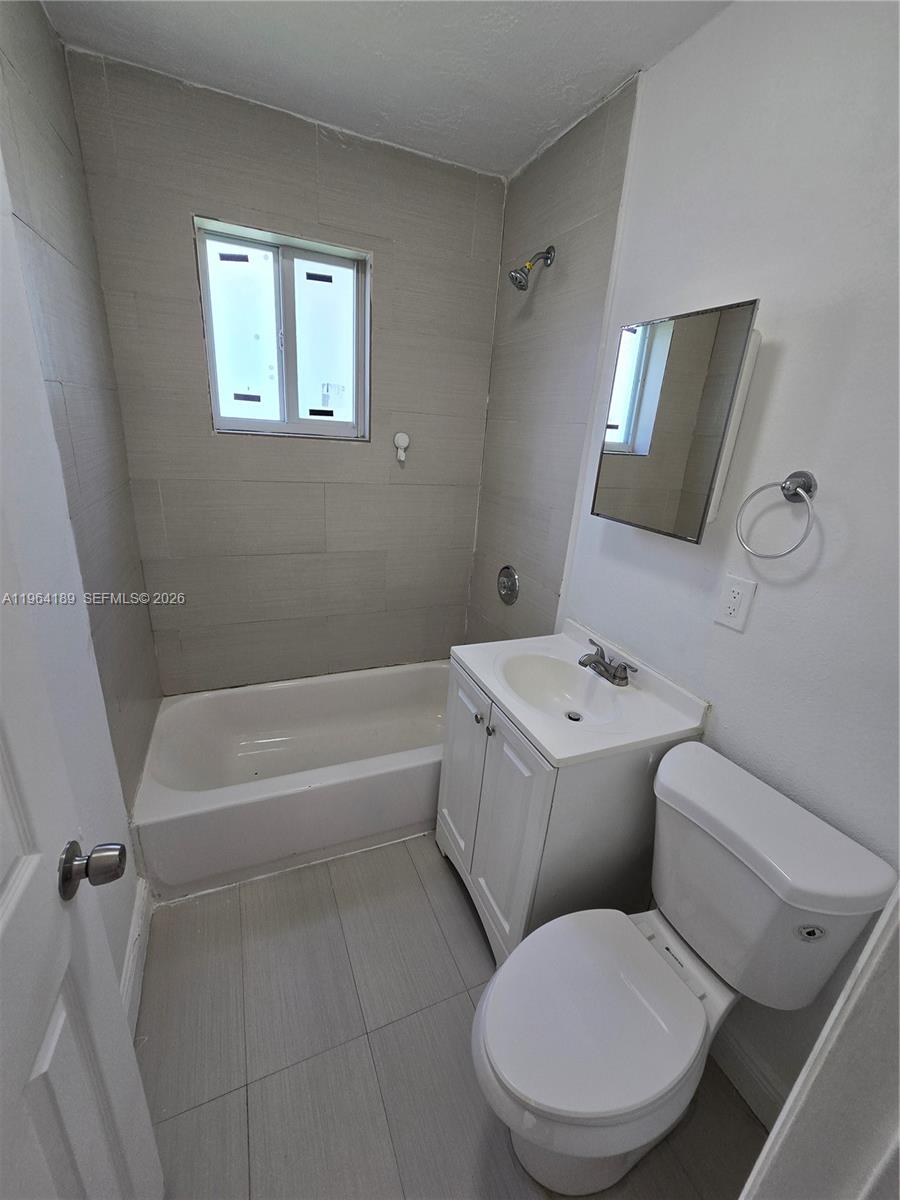 535 Northwest 7th Street, Unit 9 Miami, FL 33136 - Photo 19 of 22 a bathroom with a toilet a sink and bathtub