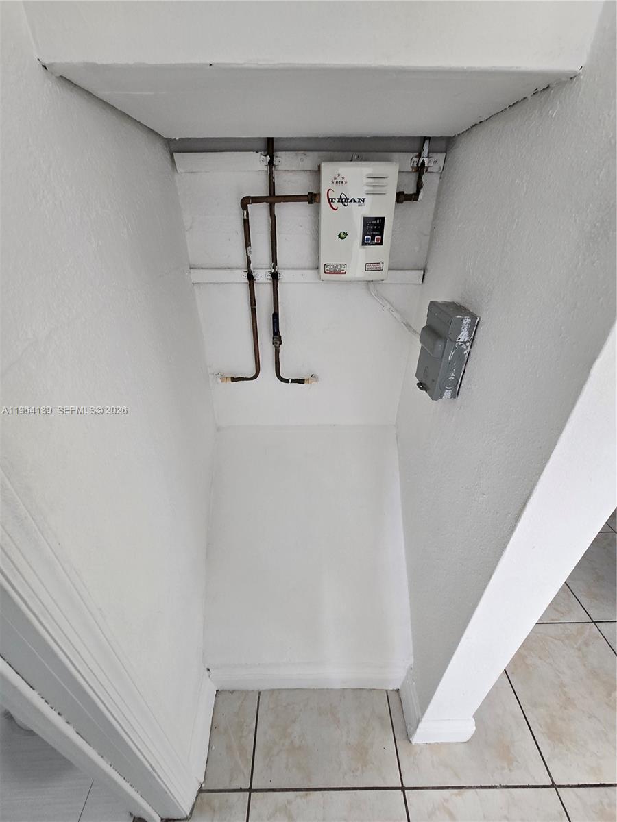 535 Northwest 7th Street, Unit 9 Miami, FL 33136 - Photo 22 of 22 a view of storage and utility room with racks on the wall