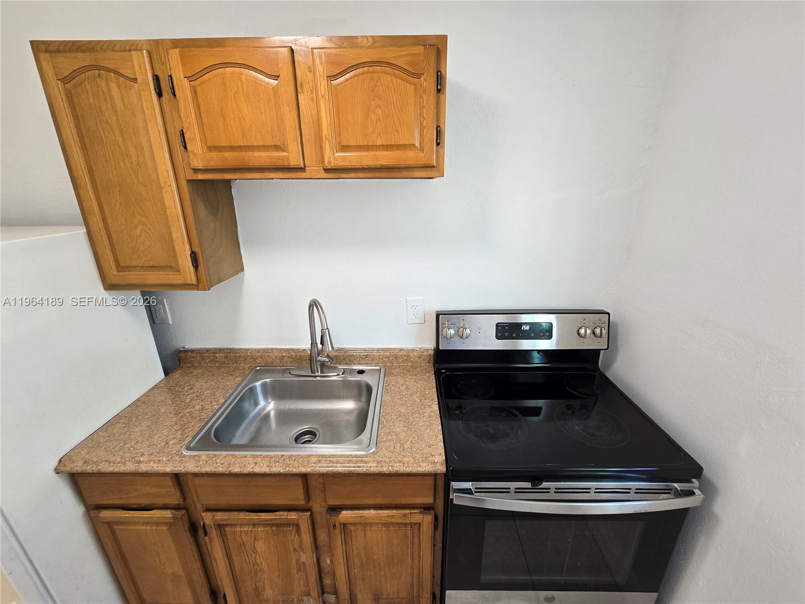 535 Northwest 7th Street, Unit 9 Miami, FL 33136 - Photo 3 of 22 a stove top oven sitting inside of a kitchen