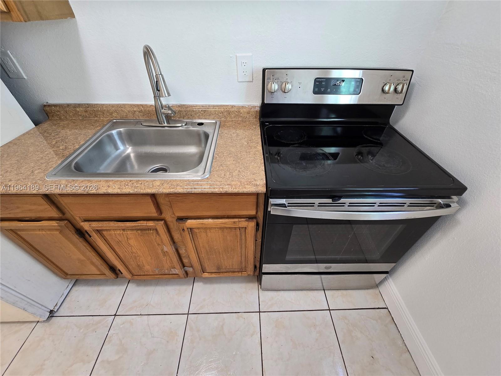 535 Northwest 7th Street, Unit 9 Miami, FL 33136 - Photo 4 of 22 a kitchen with a sink and cabinets