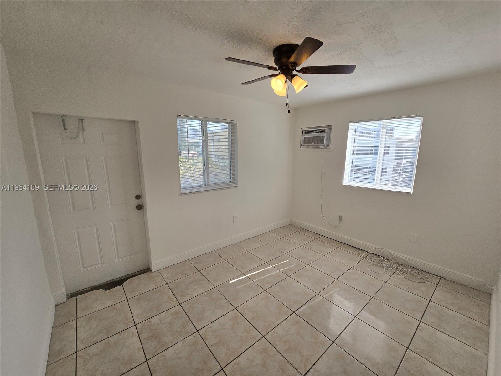 535 Northwest 7th Street, Unit 9 Miami, FL 33136 - Photo 6 of 22 a view of an empty room and window