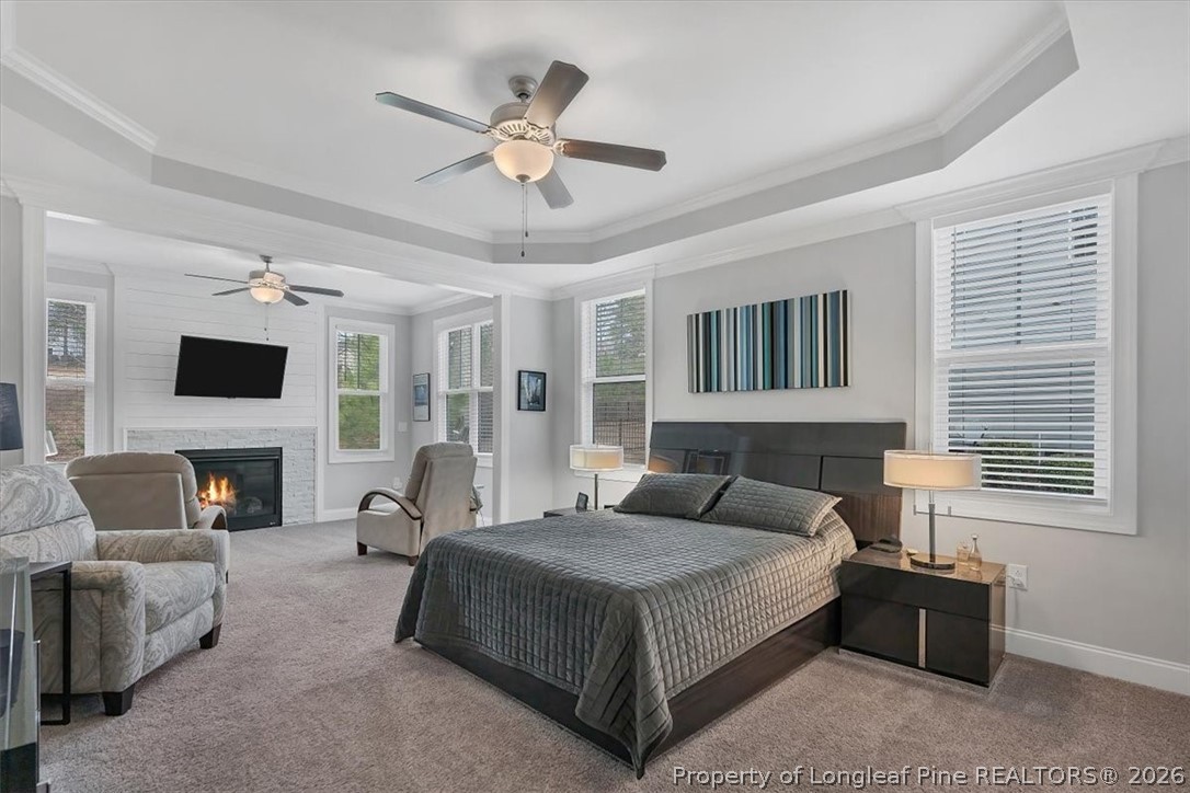 10 Heatherspring Way Spring Lake, NC 28390 - Photo 26 of 48 a spacious bedroom with a large bed a flat tv screen and a fireplace