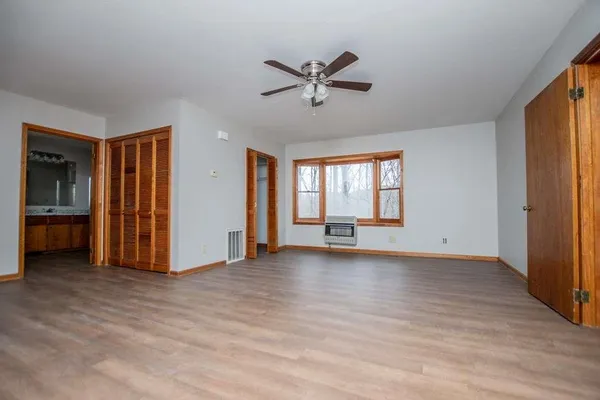 a view of an empty room with wooden floor