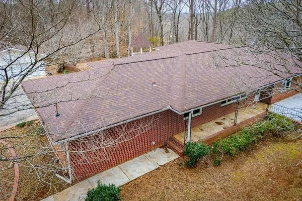 a front view of house with yard and trees around