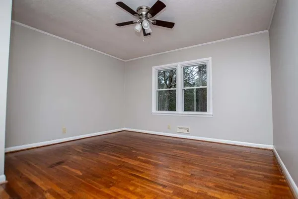 a street view covered with snow in front of house